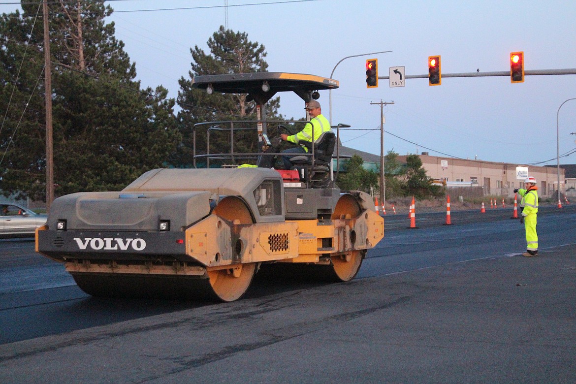 A roller compacts newly laid asphalt on SR 17. Work near Moses Lake is getting closer to completion as new portions of smooth pavement cover rough road base regularly.