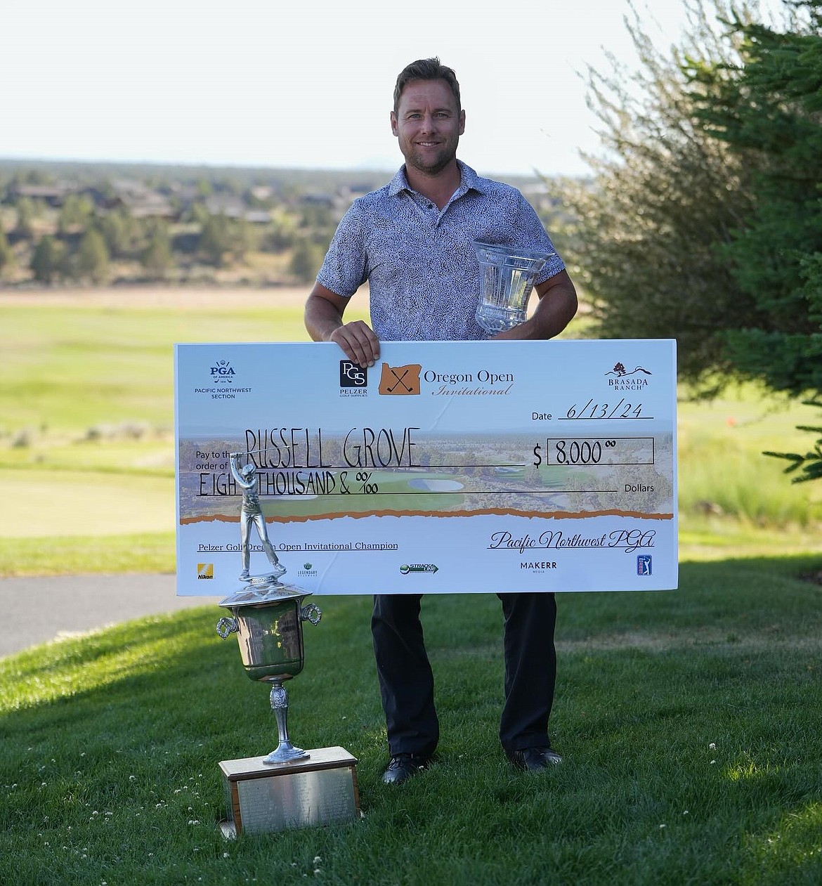 Photo by MAKERR MEDIA
Russell Grove displays the winner's check after capturing the Oregon Open golf tournament on the fifth hole of a playoff Thursday in Powell Butte, Ore.