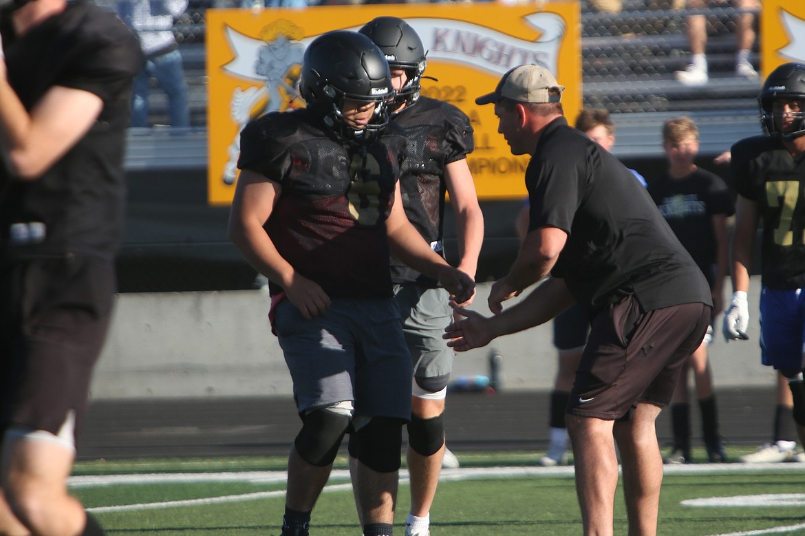 Royal Defensive Coordinator Jeremy Scroggins, right, works with a Royal player during Tuesday’s spring jamboree in Royal City. Scroggins said an aspect of his coaching philosophy is to empower the players.