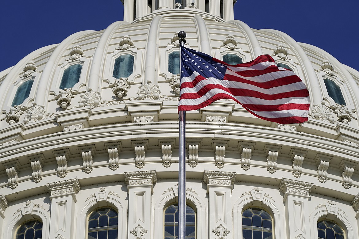 An American flag waves below the U.S. Capitol dome on Capitol Hill in Washington, June 9, 2022. (AP Photo/Patrick Semansky, File)