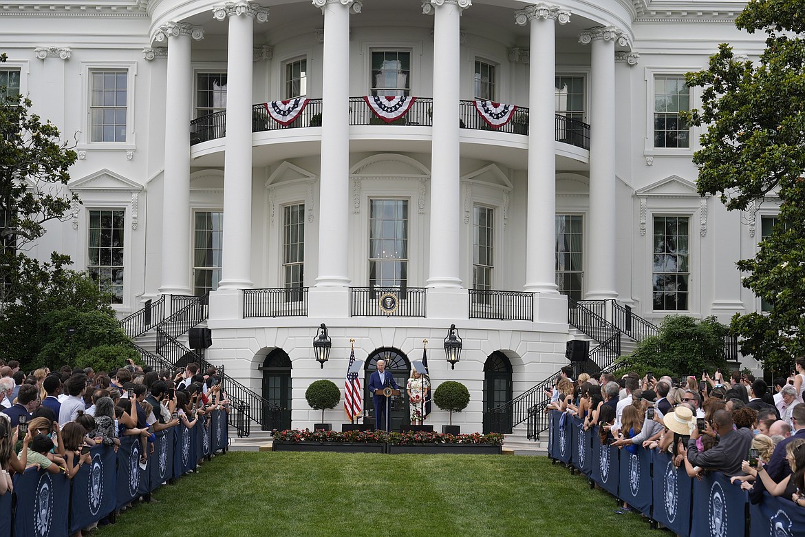 President Joe Biden, accompanied by first lady Jill Biden, speaks during a Congressional picnic on the South Lawn of the White House in Washington, Tuesday, June 4, 2024. (AP Photo/Alex Brandon)