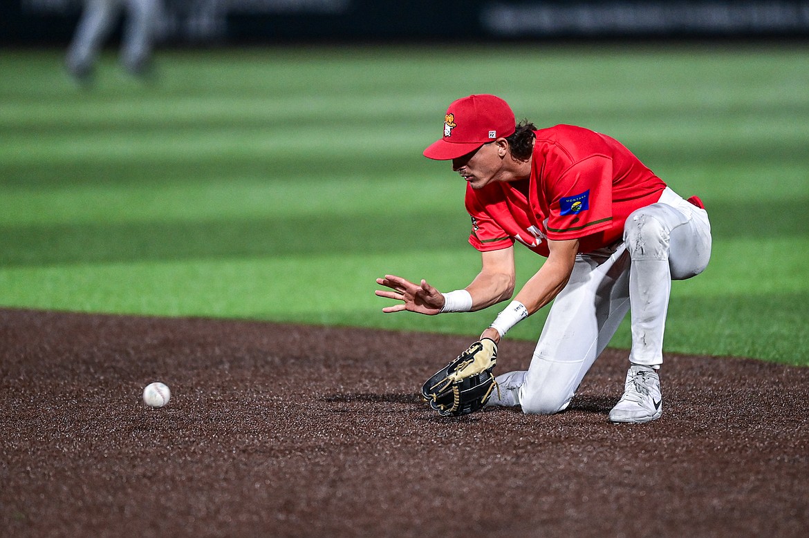 Glacier second baseman Mason Dinesen (23) watches a grounder into his glove against the Idaho Falls Chukars at Glacier Bank Park on Friday, June 14. (Casey Kreider/Daily Inter Lake)