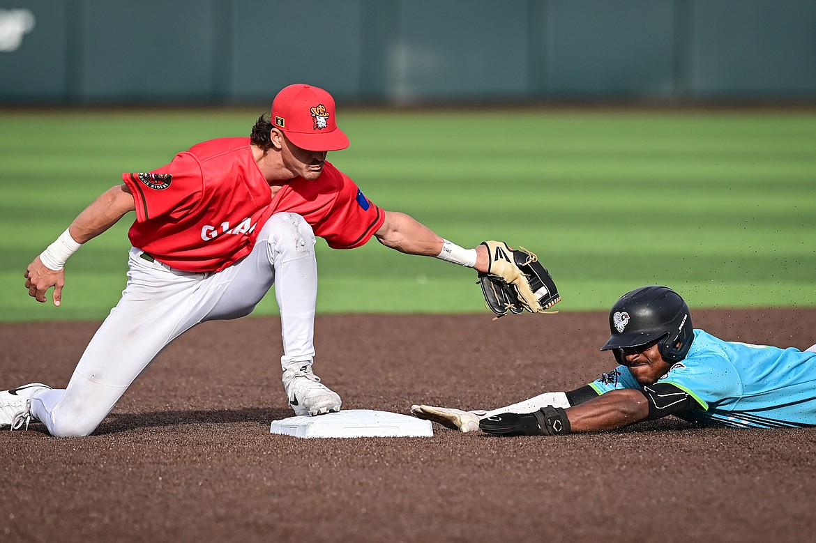 Idaho Falls' Zaid Walker (21) slides into second base under the tag of Glacier second baseman Mason Dinesen (23) in the first inning at Glacier Bank Park on Friday, June 14. (Casey Kreider/Daily Inter Lake)