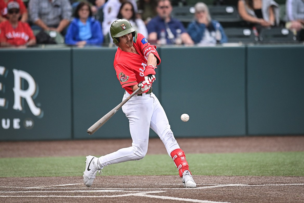 Glacier's Mason Dinesen (23) connects on a two-run single in the third inning against the Idaho Falls Chukars at Glacier Bank Park on Friday, June 14. (Casey Kreider/Daily Inter Lake)