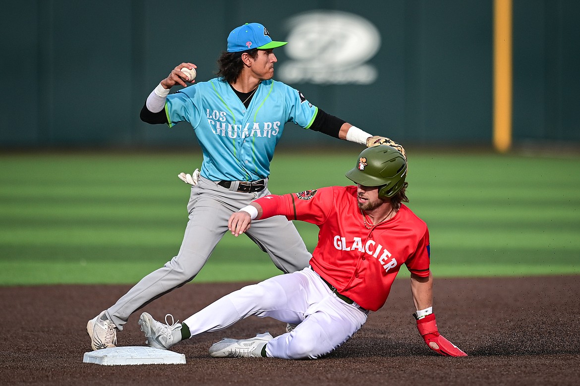 Idaho Falls shortstop Brandon Bohning (12) tries to turn a double play in the second inning, forcing out Glacier's John Daly at second at Glacier Bank Park on Friday, June 14. (Casey Kreider/Daily Inter Lake)