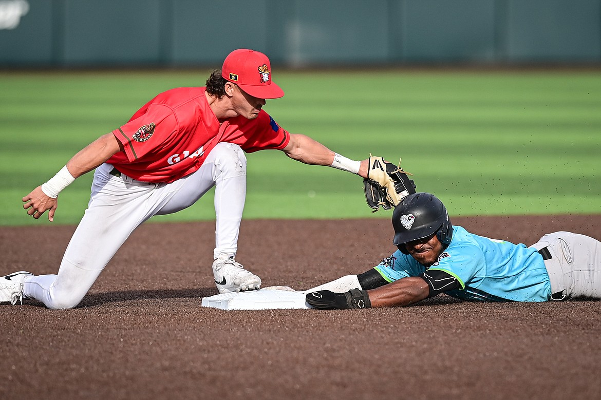 Glacier Range Riders second baseman Mason Dinesen (23) tags Idaho Falls' Zaid Walker (21) as he slides into second base for a double in the first inning at Glacier Bank Park on Friday, June 14. (Casey Kreider/Daily Inter Lake)