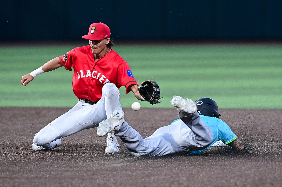 Glacier second baseman Mason Dinesen (23) applies the tag as Idaho Falls' Tyler Wyatt (9) is caught stealing in the seventh inning at Glacier Bank Park on Friday, June 14. (Casey Kreider/Daily Inter Lake)