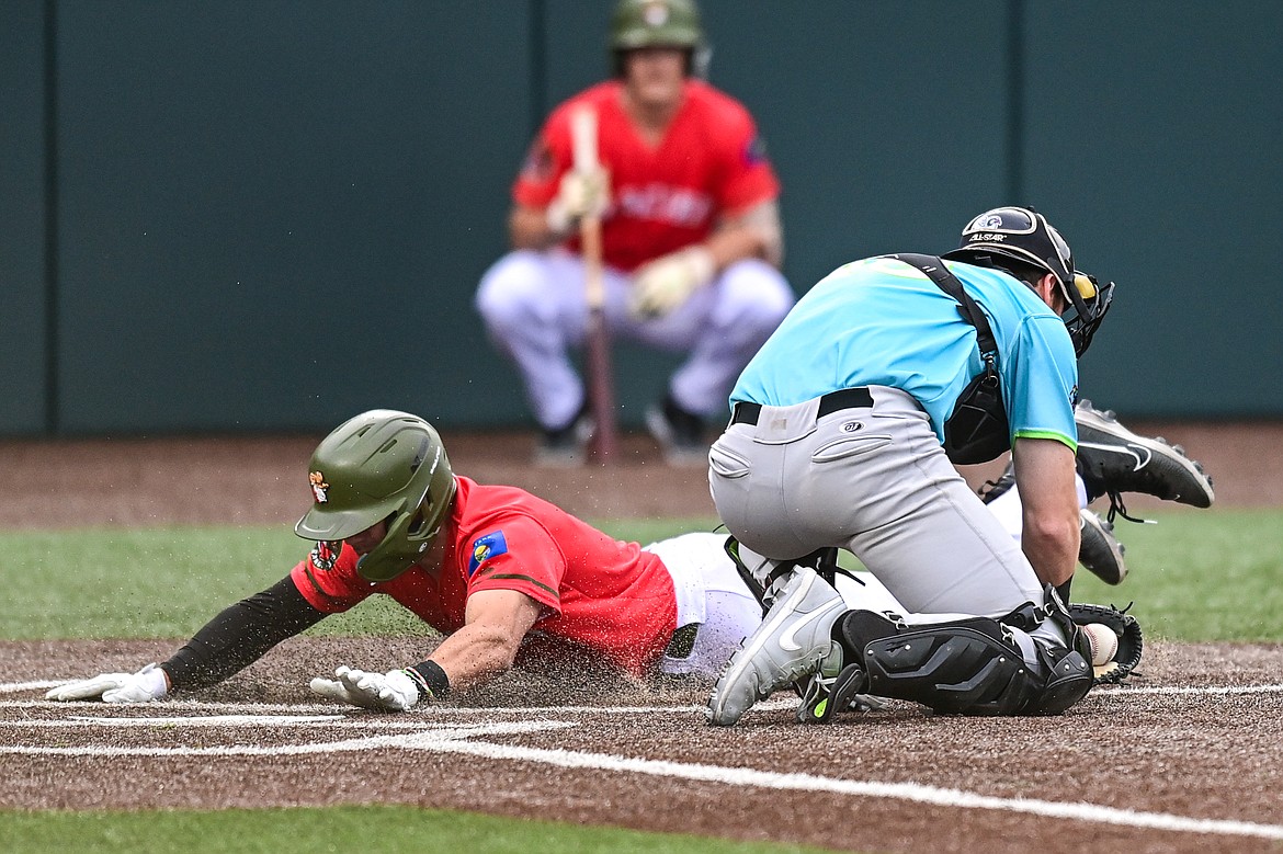 Glacier's Christian Kirtley (1) beats the tag at home plate against the Idaho Falls Chukars at Glacier Bank Park on Friday, June 14. (Casey Kreider/Daily Inter Lake)