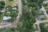 Tense moments in Mosquito Flats neighborhood as slope slumps, tipping huge trees over homes