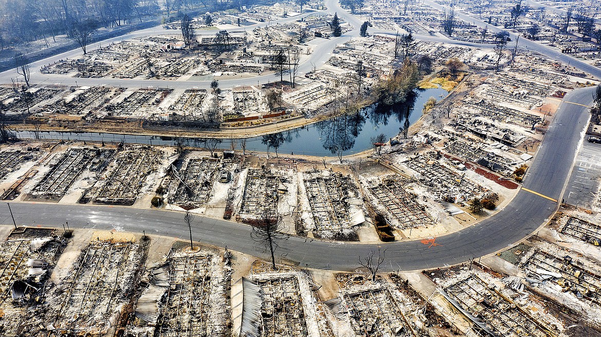 FILE - Homes leveled by the Almeda Fire are seen at Bear Lake Estates in Phoenix, Ore., on Sept. 15, 2020. Pacific Power, owned by PacifiCorp, said Monday, June 3, 2024, that it has agreed to a nearly $180 million settlement with over 400 Oregon plaintiffs who sued the utility after the deadly 2020 wildfires. (AP Photo/Noah Berger, File)