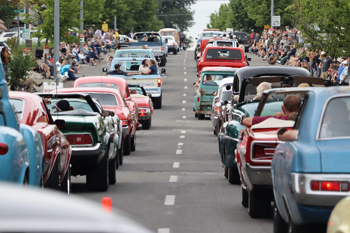 Two lines of vintage vehicles head up Fourth Street in Car d'Lane on Friday.