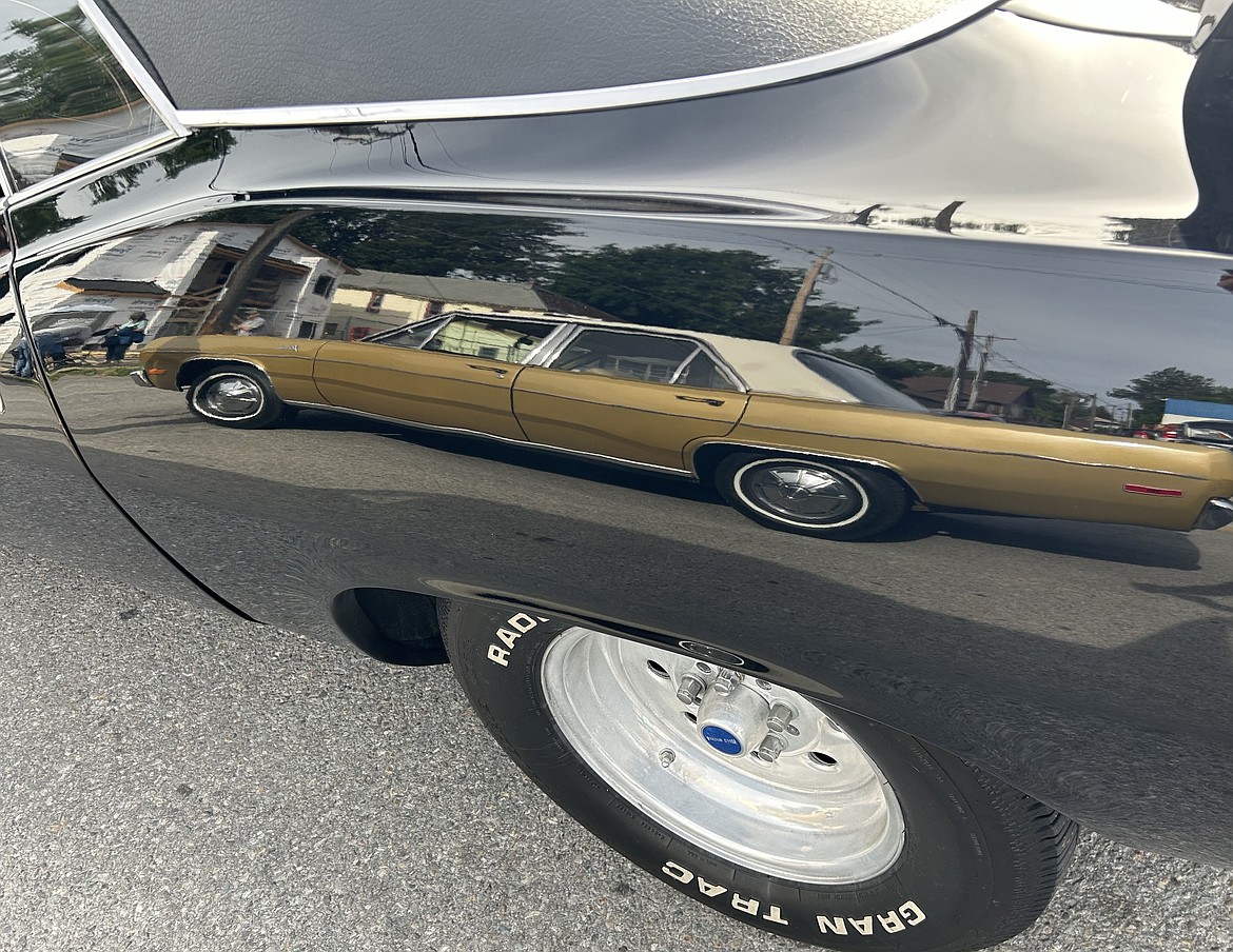 A Plymouth Valiant is reflected in another car in Car d'Lane on Friday.