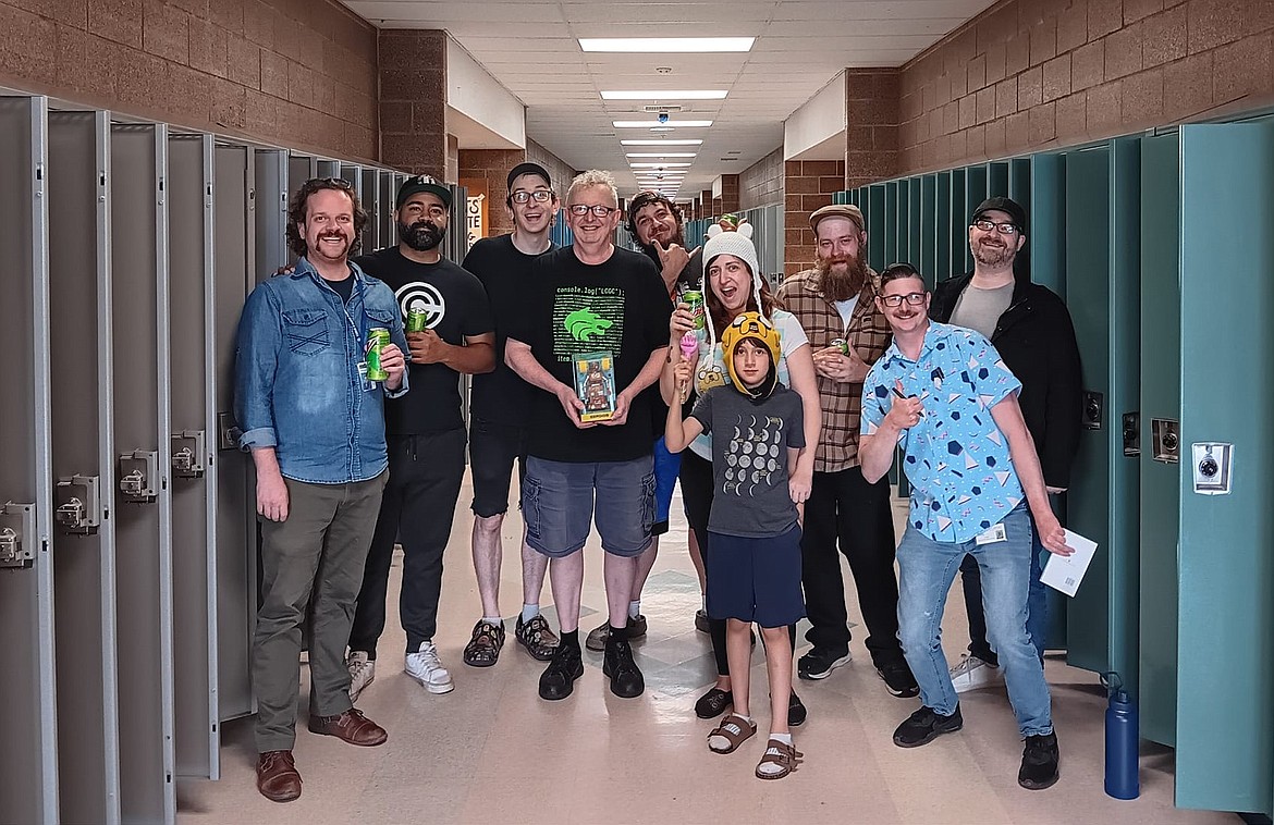 A group of former students surprised Scott Jacobson with a June 10 visit to Lake City High School before he officially retired. From left: Jimmy Robnett, Jamari Lawson, son and Lake City Game Creators founder Tyler Jacobson, Scott Jacobson, Rob Rhodes, Kaitlyn Finney Finney with son James, Talon Murray, Corey Koerner and Zachary Murray.