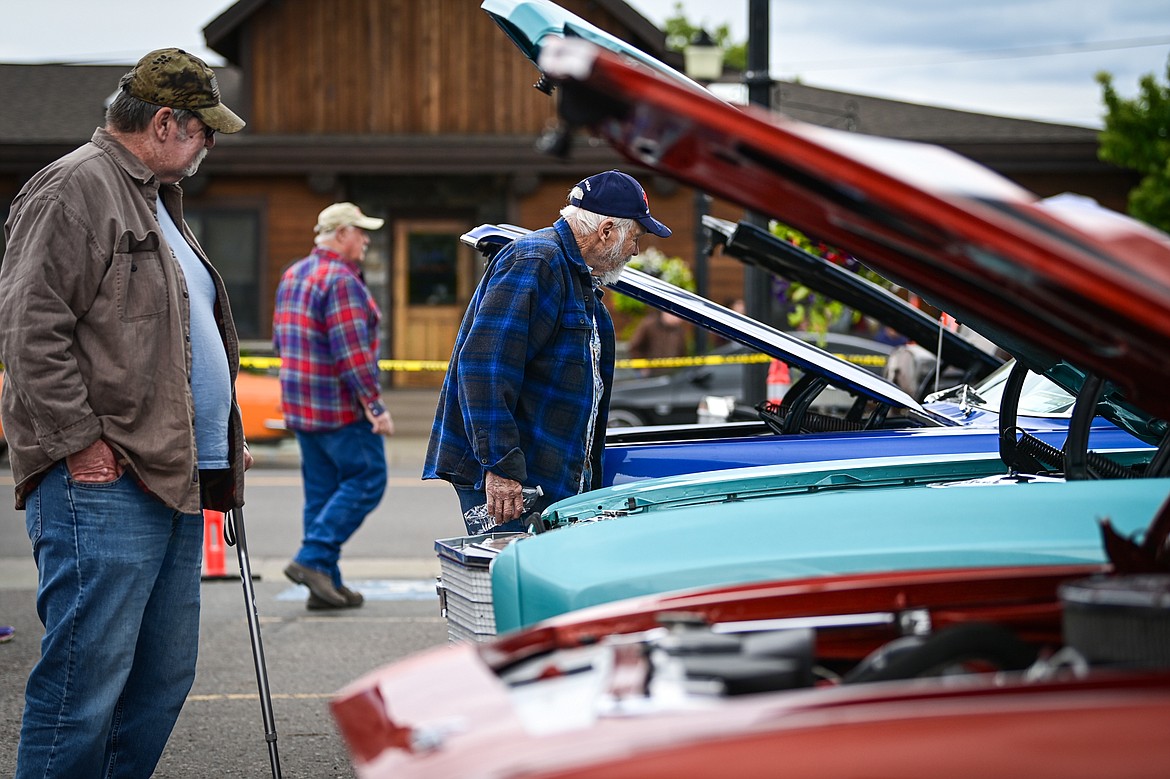 Attendees check out rows of vehicles at The Big Shindig in Kalispell on Saturday, June 15. The Big Shindig features a wide range of classic and custom vehicles as well as live music, barbeque, beer and wine and a pin-up polar plunge. Hosted the Glacier Street Rod Association and the Desoto Grill, money raised benefits Mikayla’s Miracles and Blessings Foundation. (Casey Kreider/Daily Inter Lake)