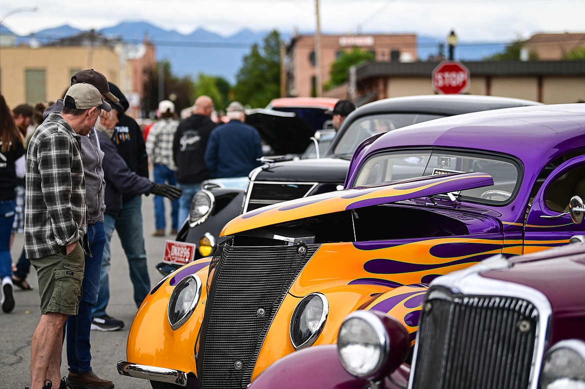 Attendees check out rows of vehicles at The Big Shindig in Kalispell on Saturday, June 15. The Big Shindig features a wide range of classic and custom vehicles as well as live music, barbeque, beer and wine and a pin-up polar plunge. Hosted the Glacier Street Rod Association and the Desoto Grill, money raised benefits Mikayla’s Miracles and Blessings Foundation. (Casey Kreider/Daily Inter Lake)