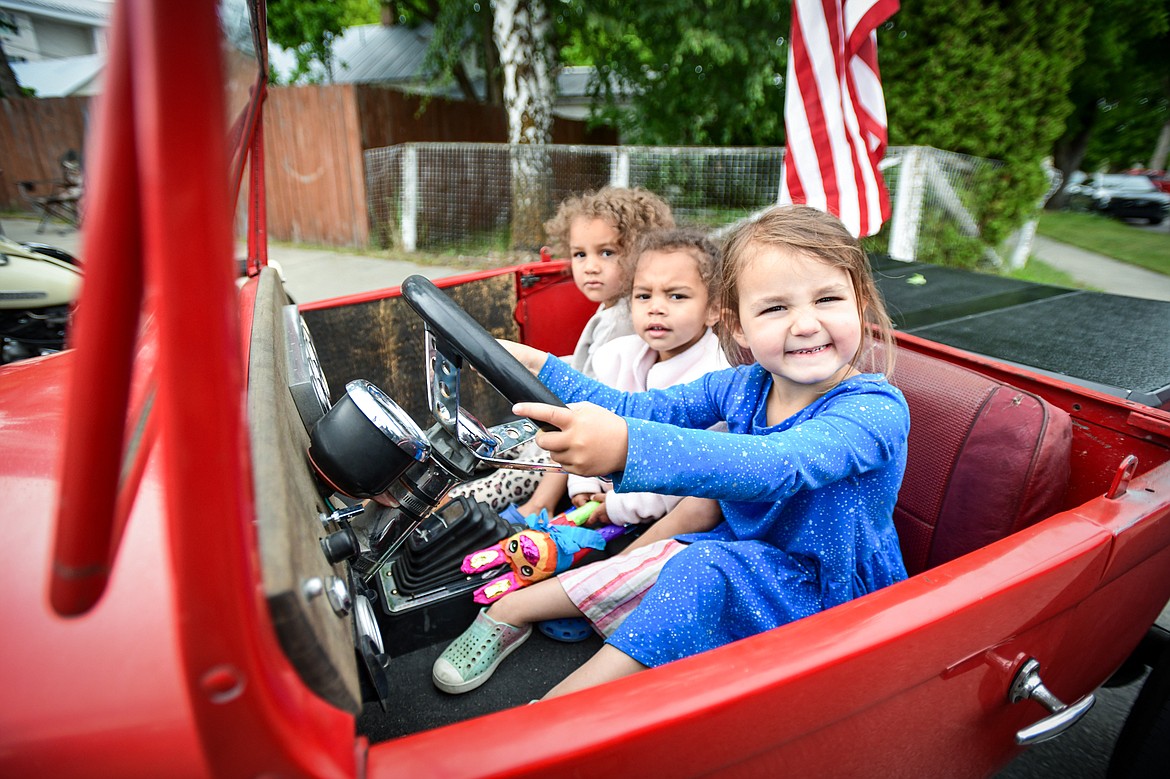 From left, Ila, Nyomi and Roxy Weidemann sit in one of the classic cars at The Big Shindig outside Desoto Grill in Kalispell on Saturday, June 15. The Big Shindig features a wide range of classic and custom vehicles as well as live music, barbecue,  and a pin-up polar plunge. Hosted by the Glacier Street Rod Association and the Desoto Grill, money raised benefits Mikayla’s Miracles and Blessings Foundation. (Casey Kreider/Daily Inter Lake)