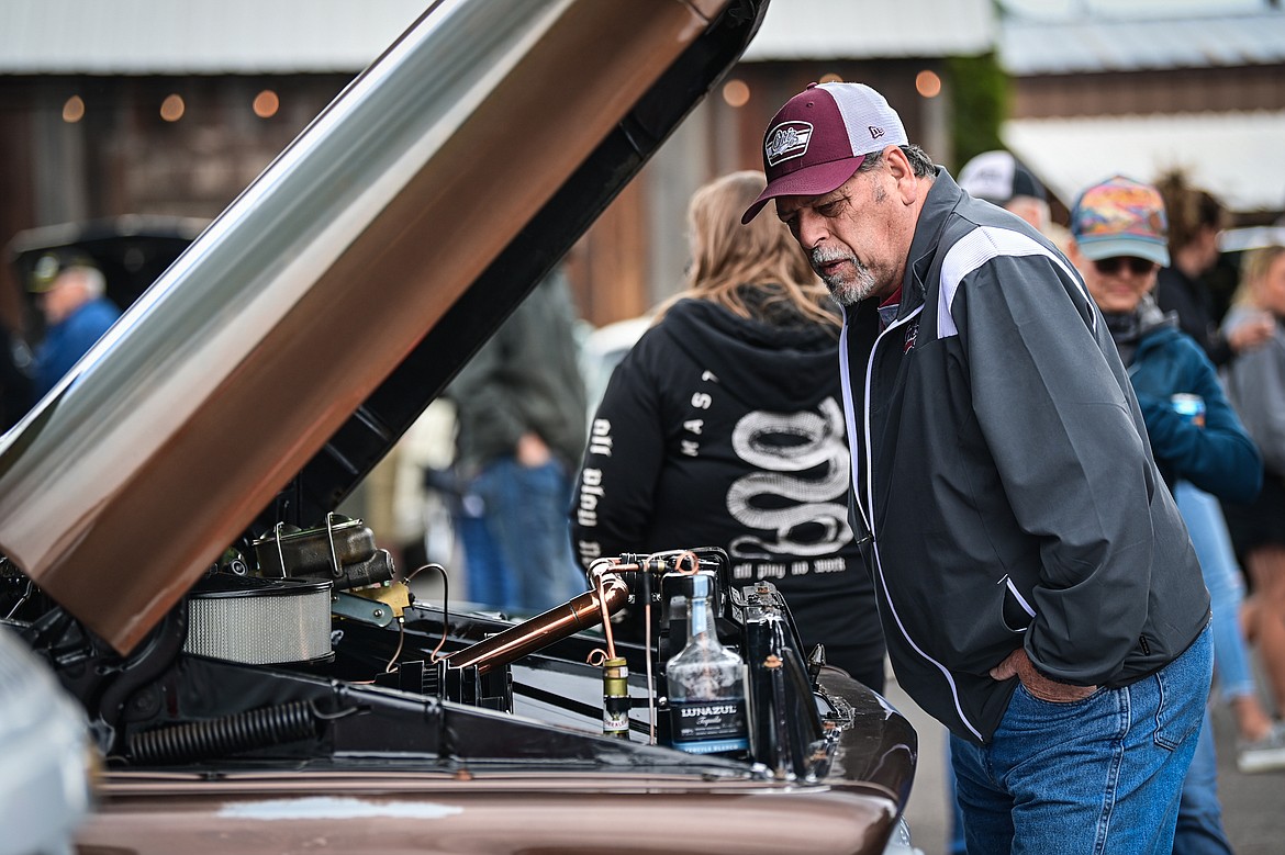 Attendees check out rows of vehicles at The Big Shindig in Kalispell on Saturday, June 15. The Big Shindig features a wide range of classic and custom vehicles as well as live music, barbeque, beer and wine and a pin-up polar plunge. Hosted the Glacier Street Rod Association and the Desoto Grill, money raised benefits Mikayla’s Miracles and Blessings Foundation. (Casey Kreider/Daily Inter Lake)