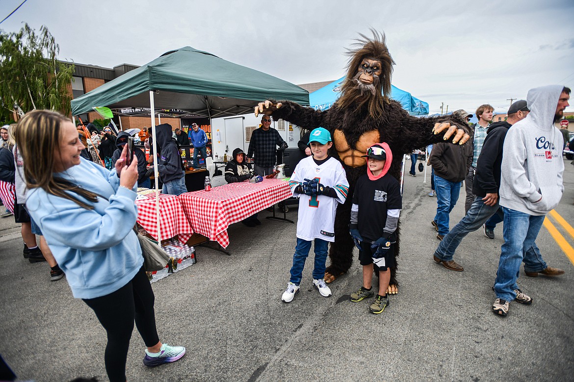 Children have their picture taken with a person dressed in a Bigfoot costume at The Big Shindig in Kalispell on Saturday, June 15. The Big Shindig features a wide range of classic and custom vehicles as well as live music, barbeque, beer and wine and a pin-up polar plunge. Hosted the Glacier Street Rod Association and the Desoto Grill, money raised benefits Mikayla’s Miracles and Blessings Foundation. (Casey Kreider/Daily Inter Lake)