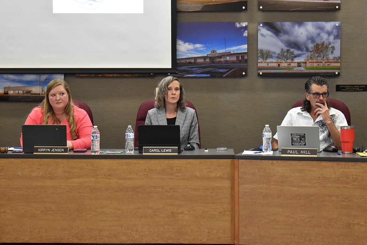 Moses Lake School Board Acting Superintendent Carol Lewis, flanked by School Board Chair Kirryn Jensen, left, and Board Member Paul Hill, explains some specifics of the district’s reduced education plan at the board’s meeting June 13.