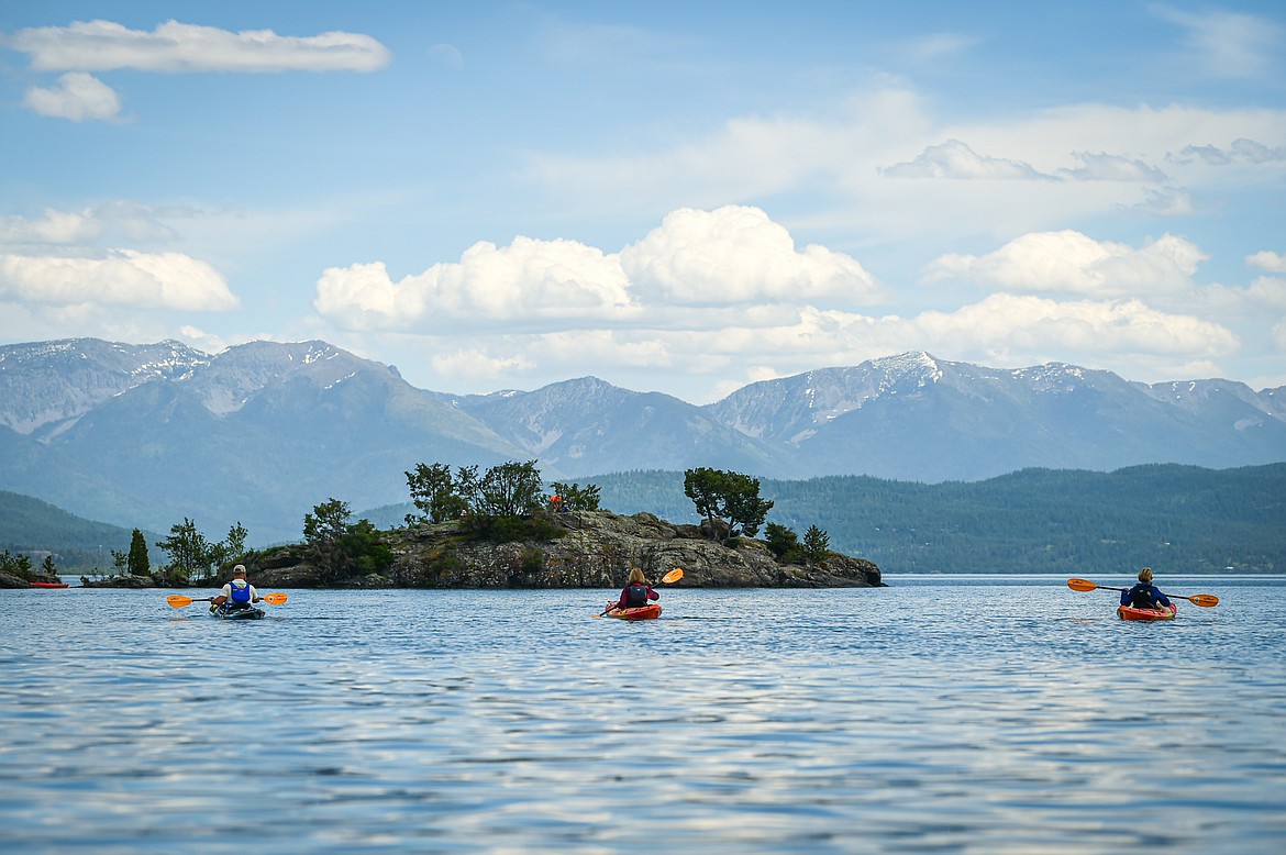 Sea Me Paddle guide Tyler Cohran leads kayakers across Flathead Lake during a tour on Friday, June 14. (Casey Kreider/Daily Inter Lake)