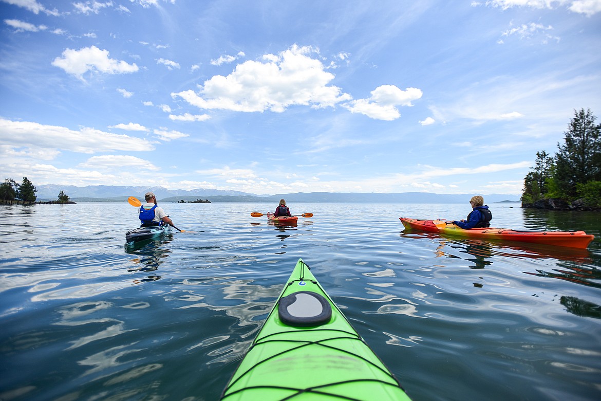 Sea Me Paddle guide Tyler Cohran leads kayakers out onto Flathead Lake from Somers Bay during a tour on Friday, June 14. (Casey Kreider/Daily Inter Lake)