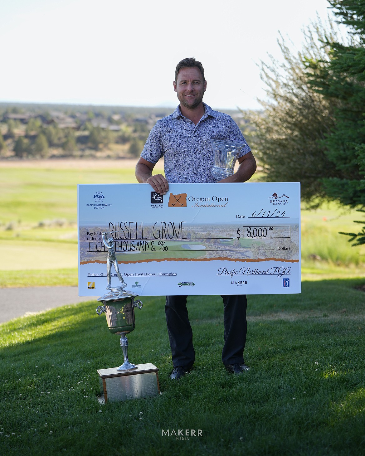 Photo by MAKERR MEDIA
Russell Grove displays the winner's check after capturing the Oregon Open golf tournament on the fifth hole of a playoff Thursday in Powell Butte, Ore.