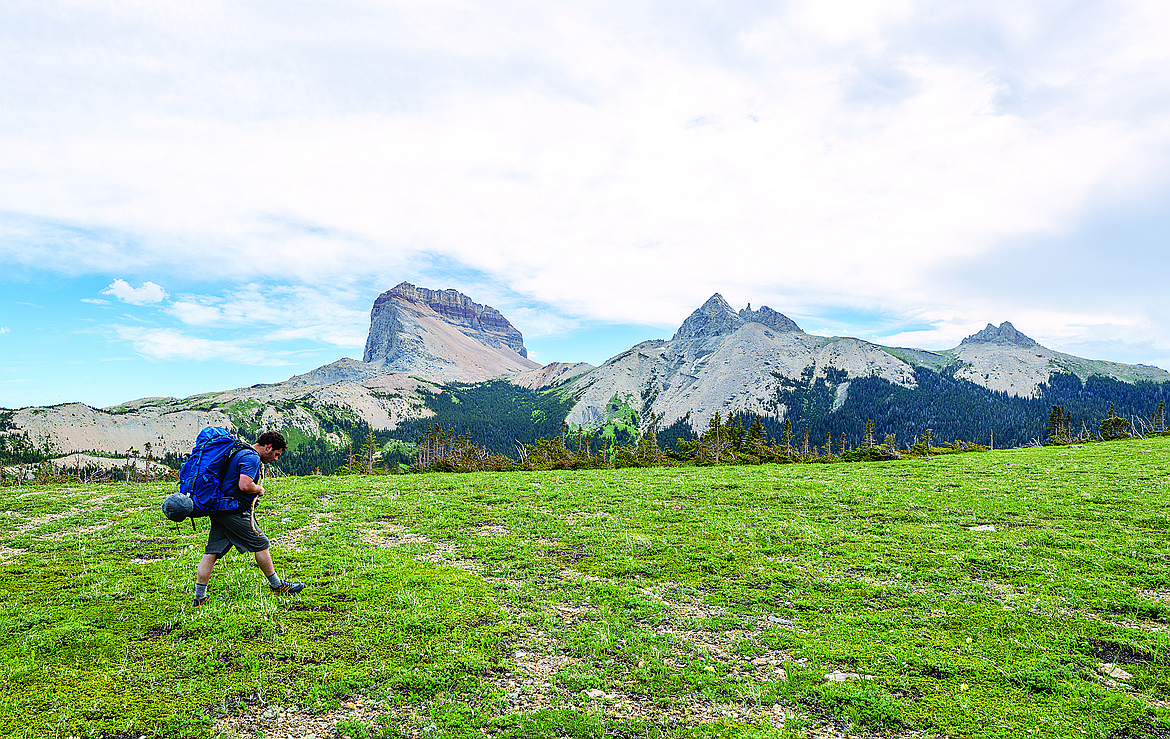 A hiker heads up Lee Ridge with with Chief Mountain in the background in Glacier National Park. (Chris Peterson/Hungry Horse News FILE)