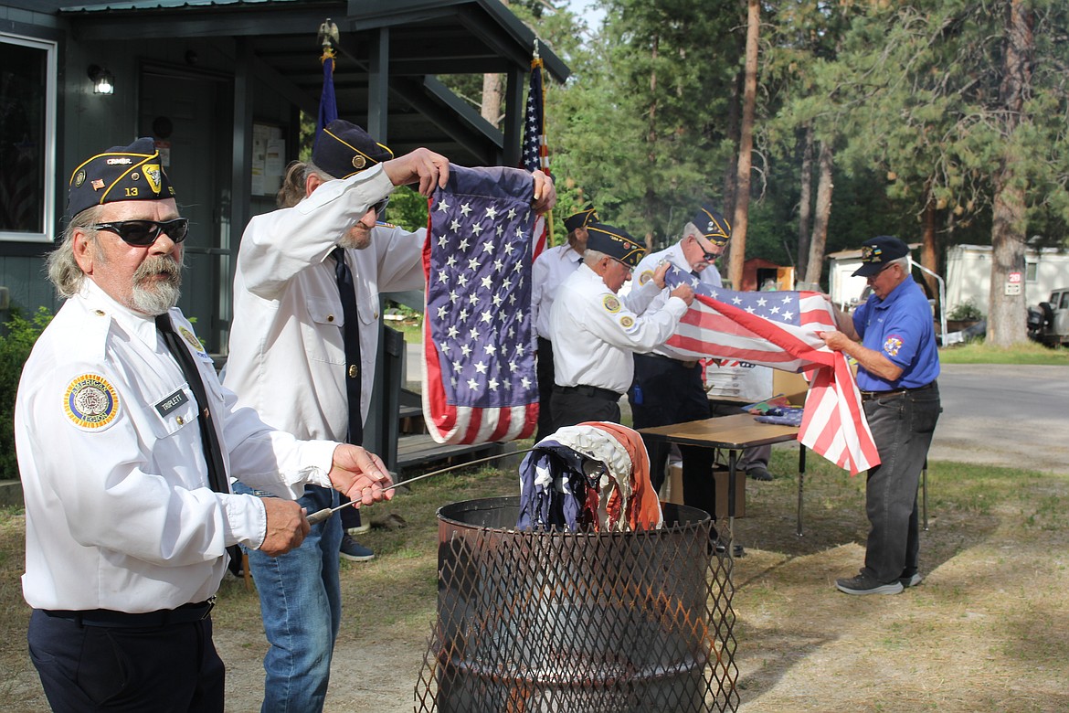 The American Legion and VFW organizations jointly held a ceremony on Flag Day for the disposal of weathered or worn American flags. (Monte Turner/Mineral Independent)