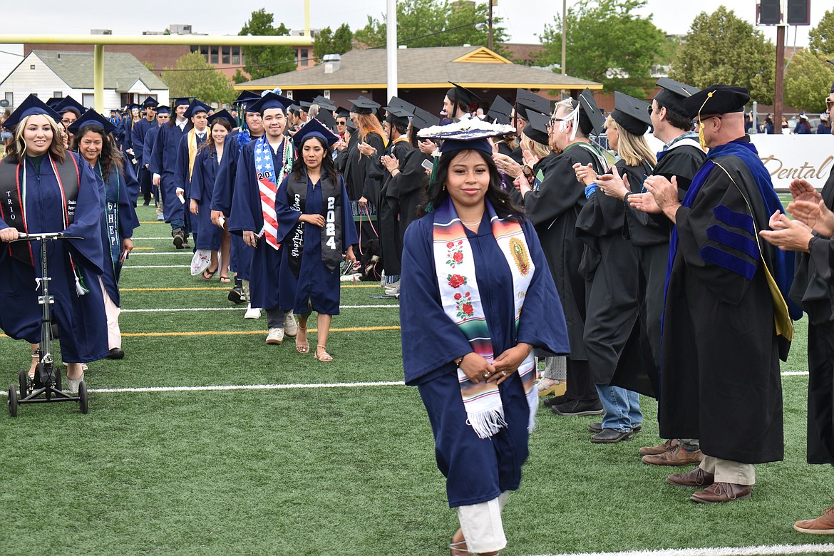 Big Bend Community College students process into their graduation ceremony Friday at Lions Field in Moses Lake.