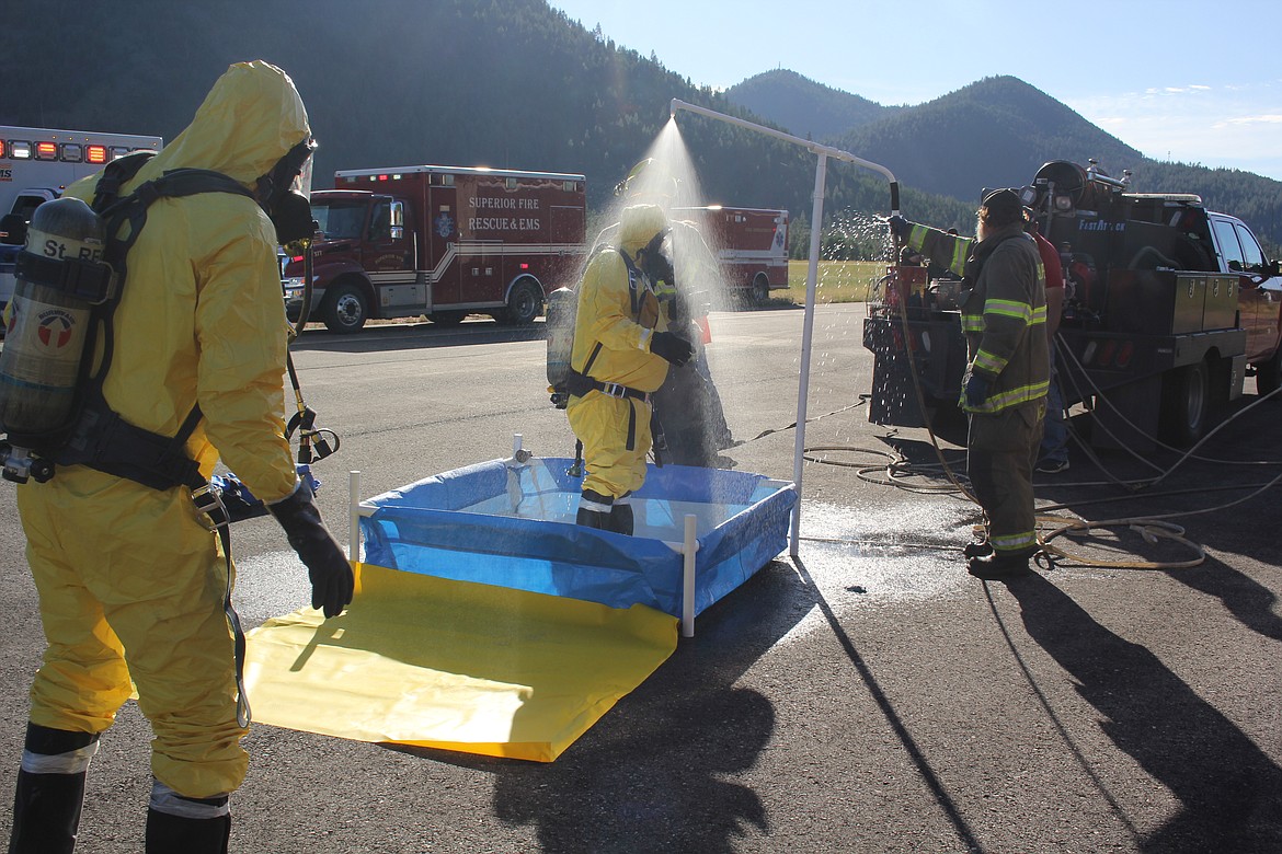 The exercise contained a hazmat chemical spill element where decontamination was required from a portable shower. (Monte Turner/Mineral Independent)