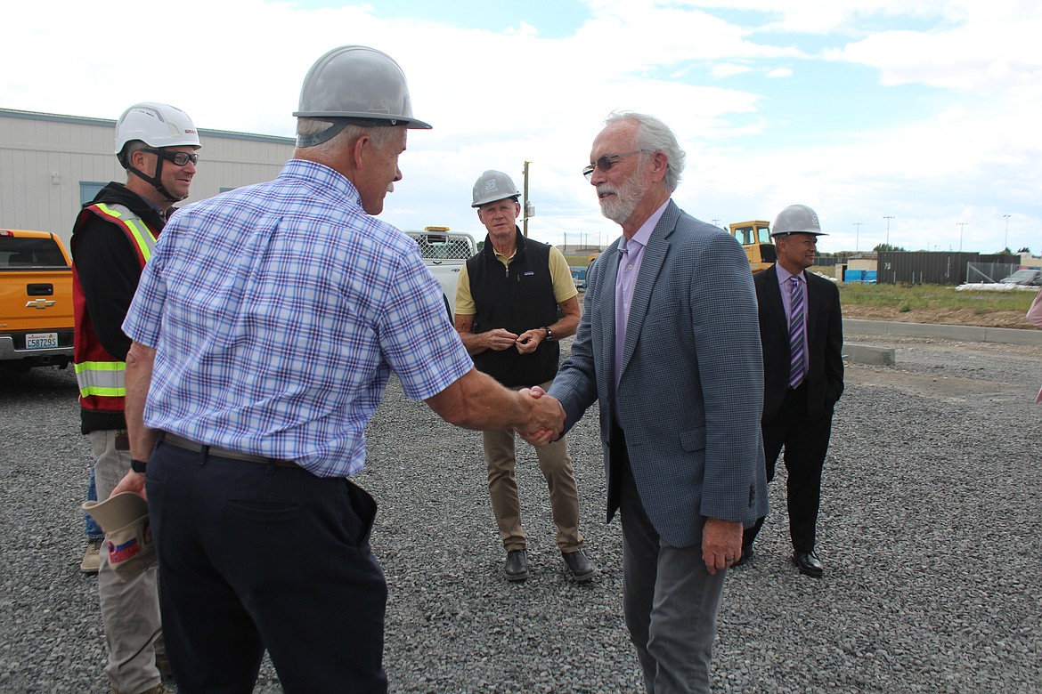 Fourth District Representative Dan Newhouse, right, shakes hands with Samaritan Healthcare commissioner Alan White, left.