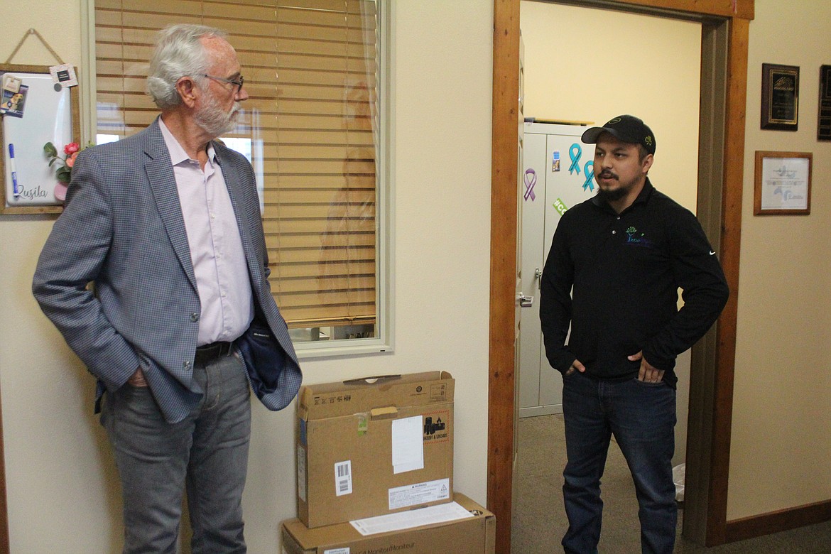 Dan Newhouse, Fourth District Representative in the U.S. House, left, talks with victim advocate Abraham Ta[pia, right, during a Monday visit to Moses Lake.