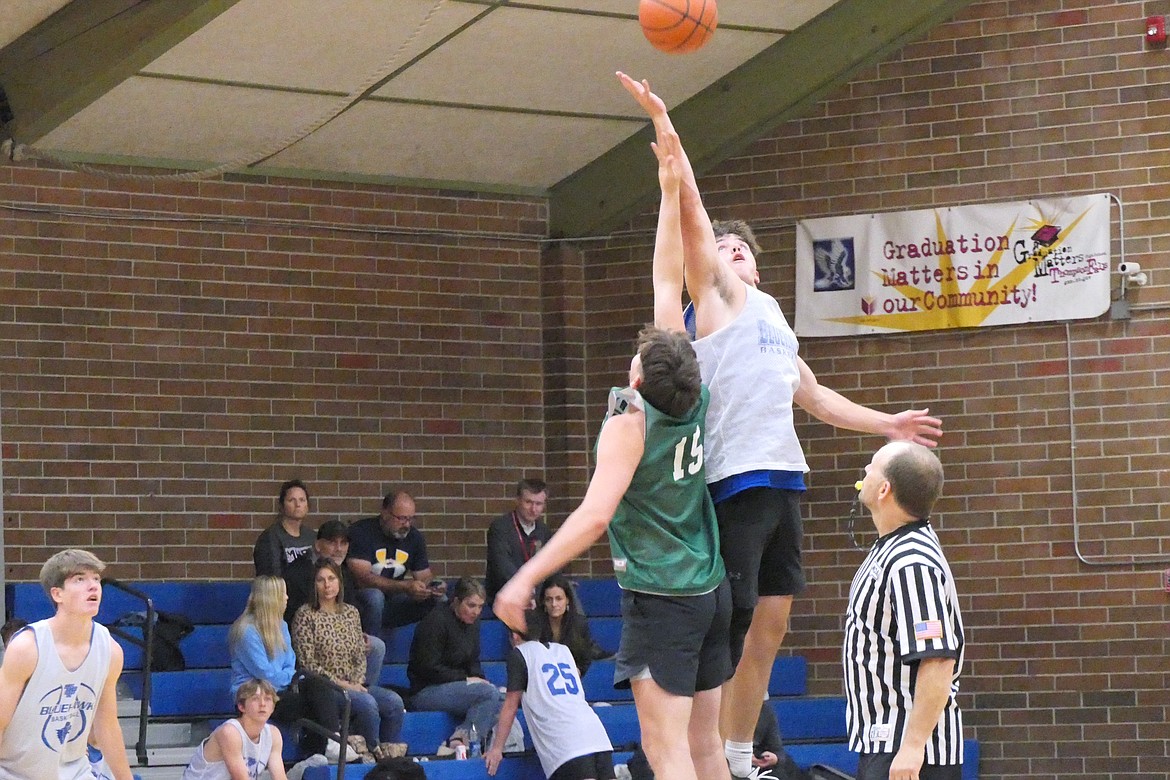 Players for St. Regis and T Falls go after the opening tip during a summer basketball game recently in T Falls. (Chuck Bandel/VP-MI)