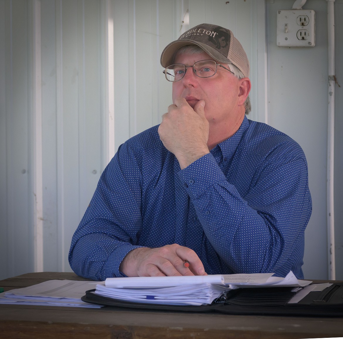 Sander County Fair Board Chairman Randy Woods reviews vendor bids. (Tracy Scott/Valley Press)