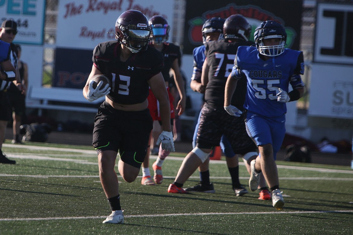 A Wahluke running back carries the ball against Warden during a June 11 scrimmage.