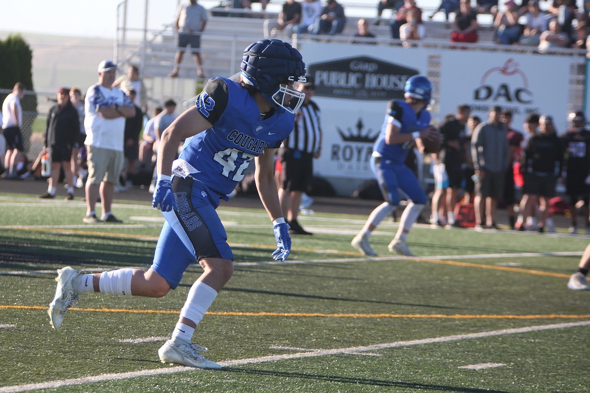 A Warden receiver runs upfield after the ball is snapped during a scrimmage against Wahluke.