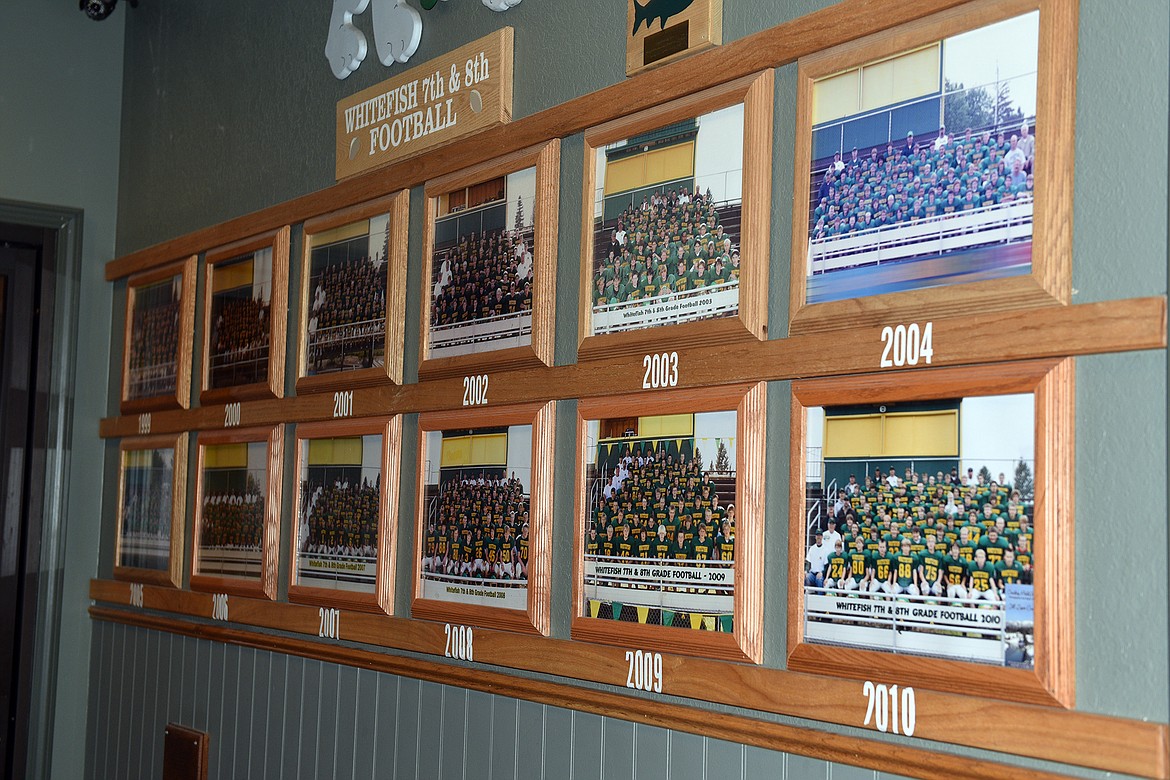 Seventh and eighth grade football team photos are displayed on the walls of the Pin and Cue. (Julie Engler/Whitefish Pilot)