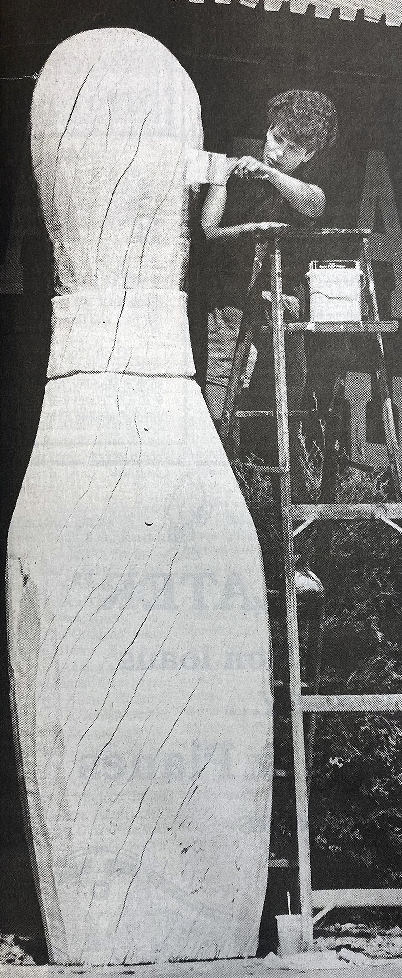 Gail Watson had to use a ladder to reach the top of the 10-foot bowling pin outside the Pin and Cue in 1994. (Mark Goldstein photo)