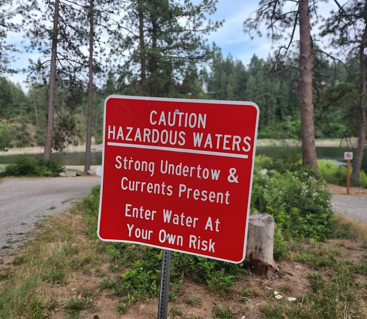 One of the multiple warning signs at Corbin Park access points along the Spokane River.