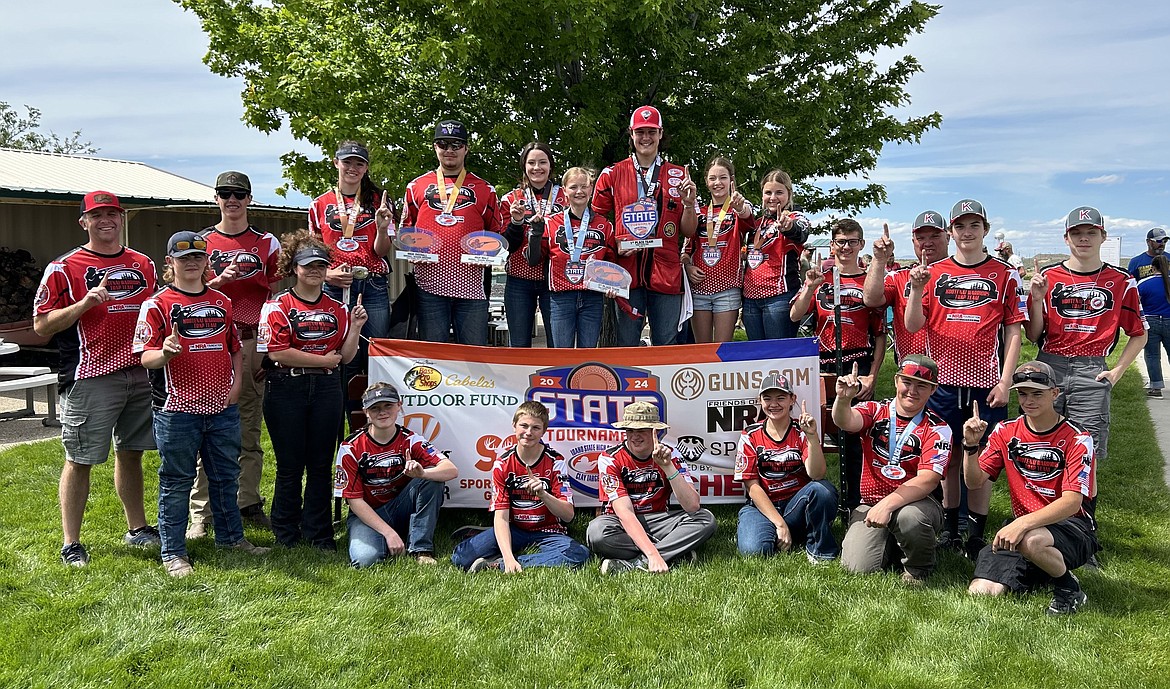The Kootenai Trap Team won first place for the third year in a row at the Idaho Trap Shooting State Championship held Saturday in Kuna. From left, back row: Coach Jake Hanson, Chance Atkin, Madsen Donohoe, Cali Mazza, Brooklyn Charles, Seth Cook, Sadie Rose Davidson, Hunter Charles, Gavin Tiller, Dani Davidson, Taryn John, Simon Hodges, coach Ron Nelson, Jonas Berkshire and Jon Henry Pearson. From left, kneeling on grass, front row: Madilyn Lowery, Cole Edwards, Noah Castles, Claire Cook, Noah Cook and Joe Brown.