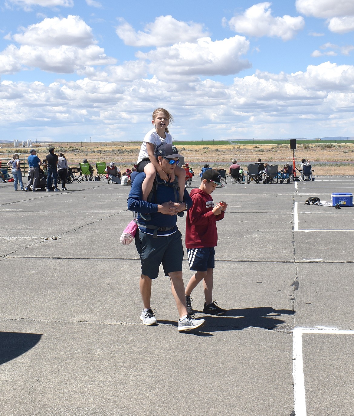 Dan Niehenke tours the Moses Lake Airshow Sunday with his children, 5-year-old Addison on his shoulders and 11-year-old Wyatt at this side. Sunday was Father’s Day, and the air show drew a lot of families to check out the aircraft.