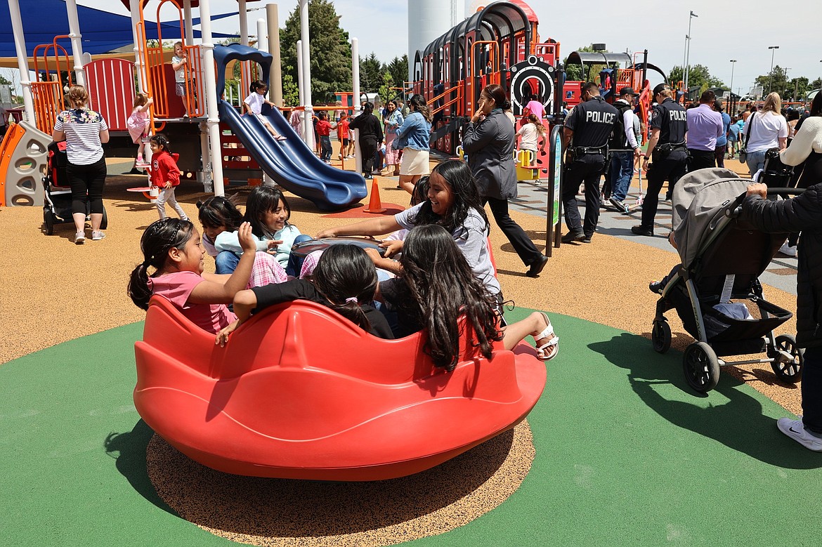 Children play on one of the new toys at the Iron Horse playground.