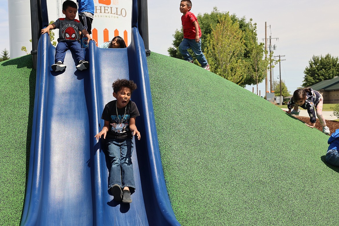 Children try out one of the new slides in the Iron Horse playground.