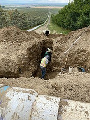 A photo of a trench being dug near Othello last fall to repair an irrigation pipe. The trench collapsed, injuring one of the workers.