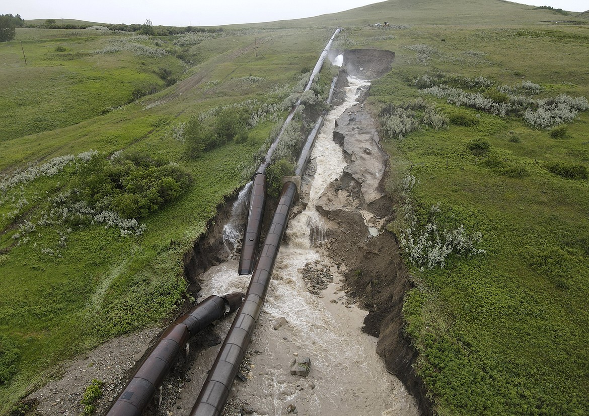 This photo released by the Bureau of Reclamation Missouri Basin Region, Montana Area Office, shows a breach in the St. Mary Canal siphon in Babb, Montana, Monday, June 17, 2024. The siphon is part of a system that carries water from a river on the Blackfeet Indian Reservation to another river that provides irrigation water to farmers and drinking water to 14,000 residents in northern Montana. No injuries or deaths have been reported since the century-old pipes broke open Monday. Officials do not know how long it will take to repair the damage. (Bureau of Reclamation Missouri Basin Region, Montana Area Office via AP)
