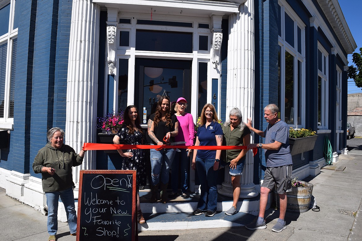 Flanked by friends and members of the Ephrata Chamber of Commerce, BreAnna Bridges cuts the ribbon at Bluebird Boutique along Basin Street in Ephrata. Bridges said the shop’s formation is the culmination of years of collecting and collaboration with friends.