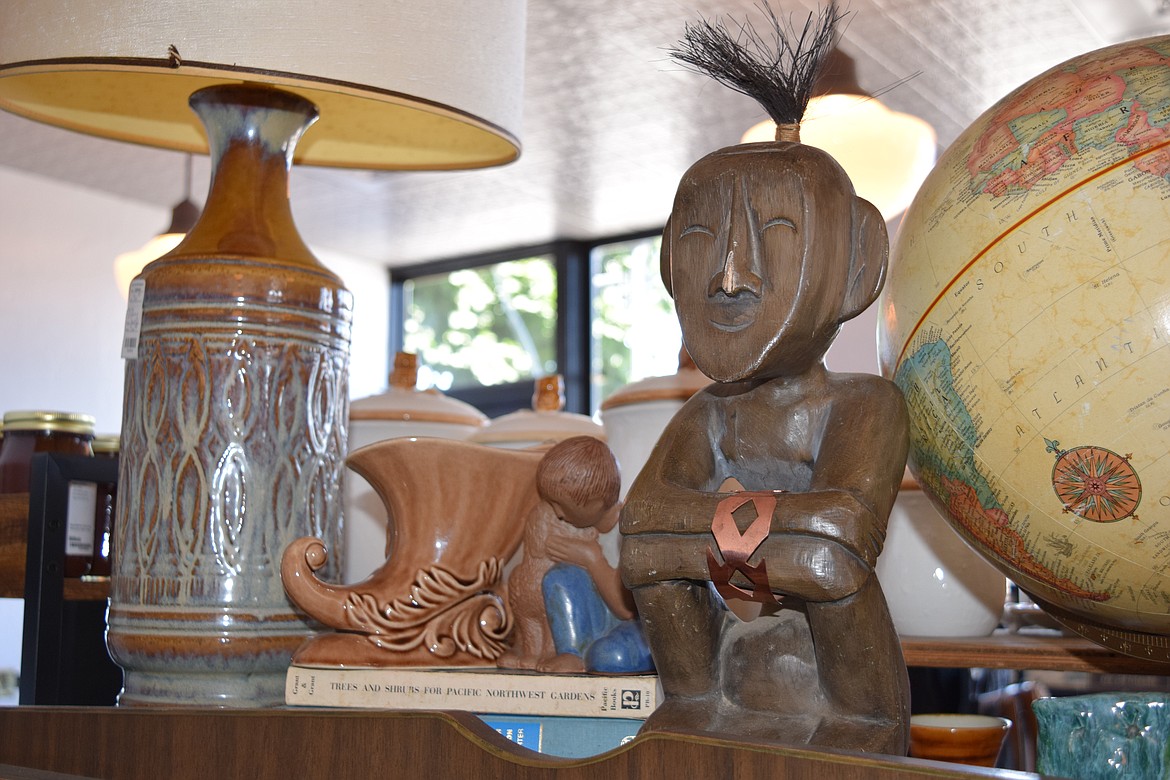 Eclectic is a good word to describe the inventory at The Bluebird Boutique. From tribal statues to globes to vintage lamps, a touch of everything is on display and available for purchase. A copy of “Trees and Shrubs of the Pacific Northwest” is even available under the cornucopia figurine shown here.