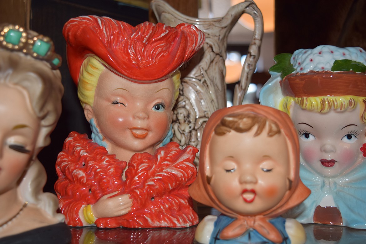 A porcelain figure gives a mischievous wink on the shelves at The Bluebird Boutique.