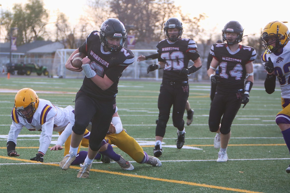 Almira/Coulee-Hartline’s Caden Correia (2) rushes past the Concrete defense during a state football playoff game on Nov. 11 in Moses Lake. Correia took over as the Warrior quarterback last fall.