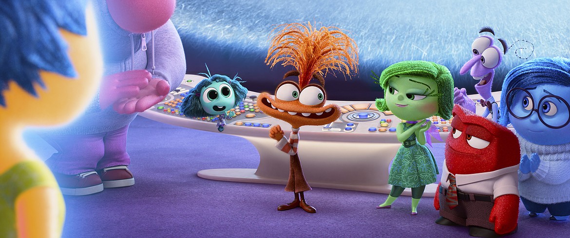 This image released by Disney/Pixar shows, from left, Joy, voiced by Amy Poehler, Embarrassment, voiced by Paul Walter Hauser, Envy, voiced by Ayo Edebiri, Anxiety, voiced by Maya Hawke, Disgust, voiced by Liza Lapira, Anger, voiced by Lewis Black (foreground), Fear, voiced by Tony Hale, and Sadness, voiced by Phyllis Smith, in a scene from "Inside Out 2."